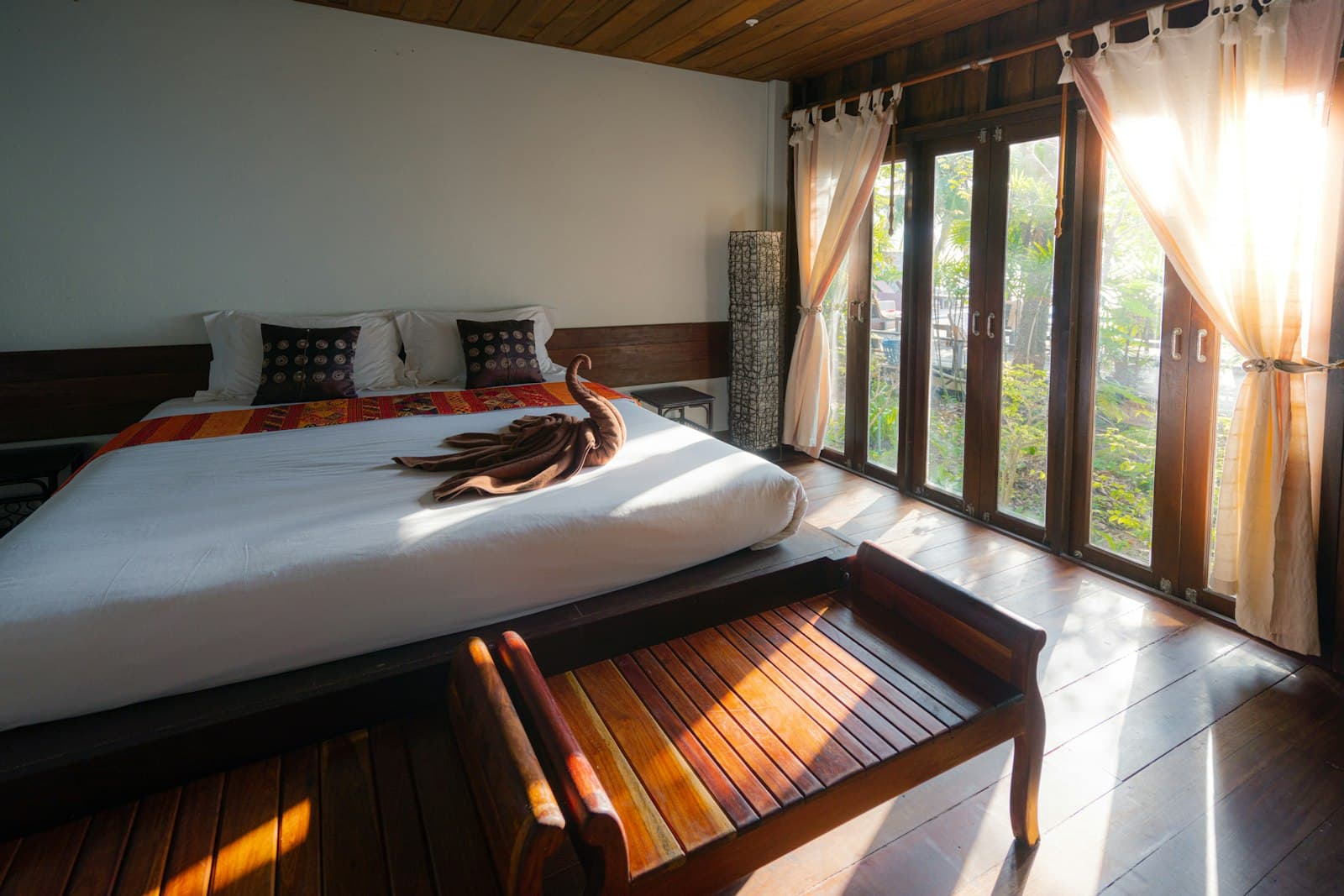 Hotel suite with soft linens and open shutters